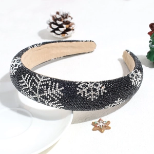 Close-up of black sponge headband with rhinestones and snowflakes for Christmas styling