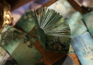 Macro view of vintage junk journal paper with fairy tale cottage and aged textures
