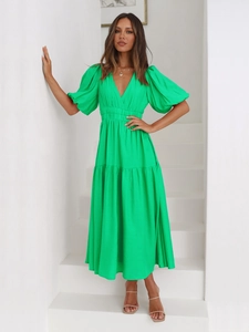 Detailed view of the deep V-neck and puff sleeves on this bright green summer maxi dress