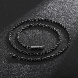 Macro detail of twisted rope chain necklace with magnetic clasp on dark background