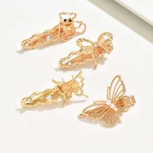 Set of four gold alloy butterfly and bear hair clips with rhinestones and pearls