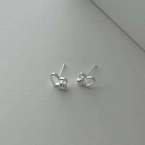 Macro shot of minimalist 925 sterling silver heart earrings with layered hollow design