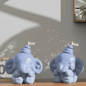 Cute blue elephant handmade candles with mini knit hats in a warm lifestyle setting