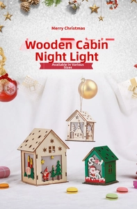 Detail of laser-cut wooden Christmas house night lights with warm glowing LED windows