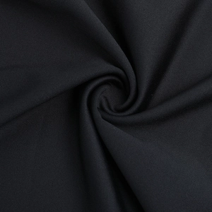 Close-up of premium black elastic fabric showing smooth texture for party dress