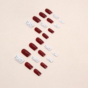 Glossy burgundy and speckled white square nail tips set with polished mirror finish