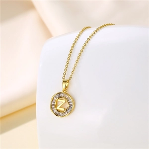 Macro detail of 18K gold stainless steel letter Z pendant with sparkling cubic zirconia