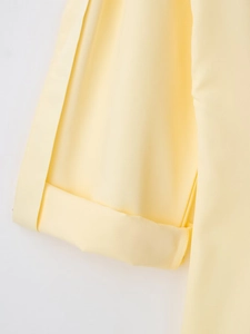 Dettaglio dei polsini dell'abito a camicia giallo pallido con trama in saia e cuciture