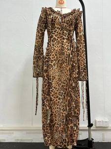 Close-up of leopard print chiffon dress featuring ruffled edges and tied sleeve details