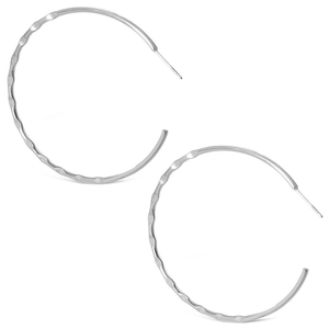 Close-up of silver C-shaped hoop earrings with hammered metal texture and wavy finish