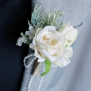 Elegant white rose boutonniere with pearls and jute handle on a grey suit jacket
