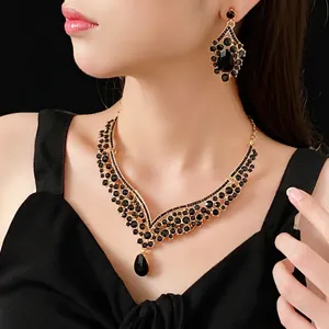 Vintage gold V-shaped necklace and earring set with black teardrop crystals