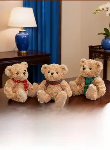 Close-up of three teddy bears with plaid scarves on a cozy wooden table setting