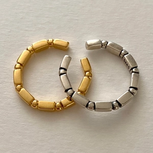 Detail of adjustable S925 sterling silver rings showing minimalist geometric link design