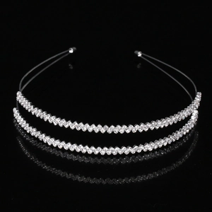 Elegant double-row rhinestone headband with silver metal base on a reflective black surface