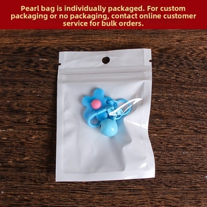 Blue flower keychain with small bell and hook in individual pearlescent packaging