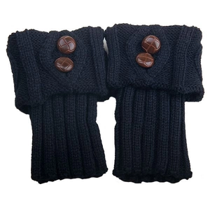 Detailed close-up of dark blue knit leg warmers with vintage brown textured buttons