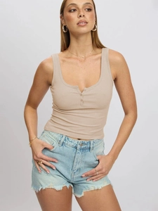 Detailed macro view of the knitted ribbed texture and three-button neckline on the beige vest