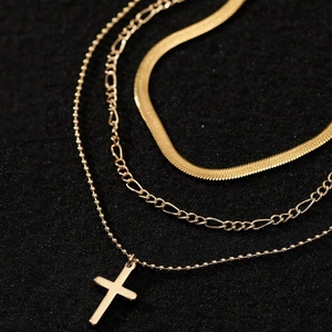 Three-layer gold-plated chain necklace featuring a cross pendant and sleek snake chain style