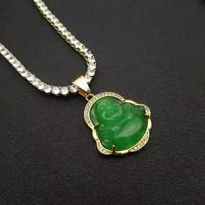 Detail of gold-plated Buddha pendant with green stone and sparkling zircon chain
