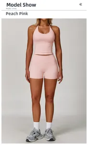 Detail view of peach pink halter yoga top and high waist shorts on a professional model