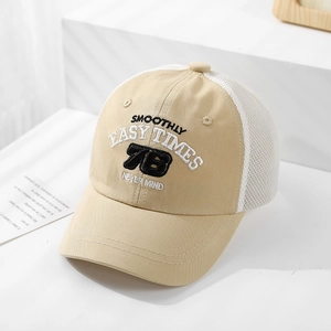 Detail of khaki kids trucker hat with embroidered letters and white breathable mesh