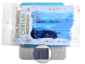 Blue foil fringe curtain showing actual weight of 37.3 grams on a digital scale