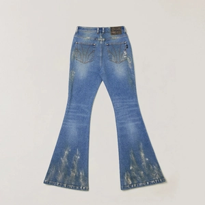 Detail of vintage flare jeans showing distressed sandblasted hem and denim texture