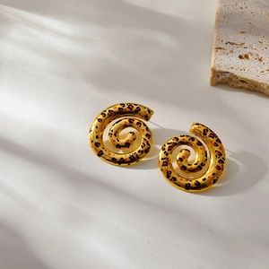 Detailed macro view of 18k gold plated spiral earrings with leopard print patterns