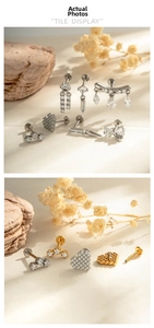 Detail showing various micro-inlaid zircon earrings and bow-knot studs on a stone surface