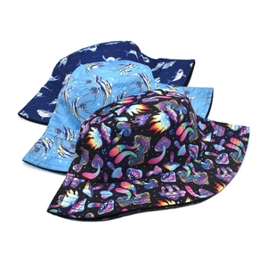 Double-sided sun hat featuring deep blue shark and colorful mushroom patterns