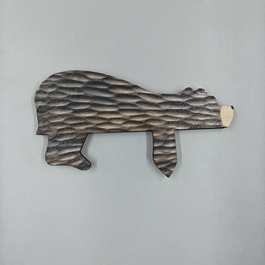 Detail of handcrafted wooden brown bear door stopper showing wood carving textures