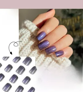 Macro shot of short purple cat-eye press-on nails with sparkling magnetic shimmer effect
