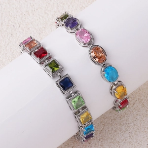 Detail of square and oval cut multi-color zircon bracelets on a white cylinder stand