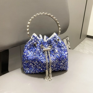 Detailed shot of blue bucket bag featuring sparkling rhinestones and metal ring handle