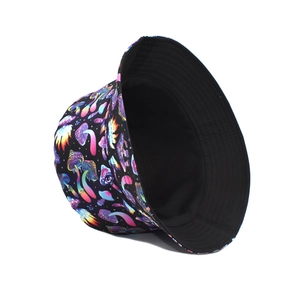 Detail of double-sided bucket hat featuring colorful neon mushroom print on black canvas