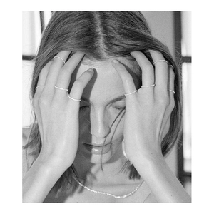 Minimalist stackable pave cubic zirconia rings displayed on a model in a high-fashion style