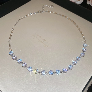Close-up of sparkling round-cut zircon necklace with silver chain and adjustable clasp