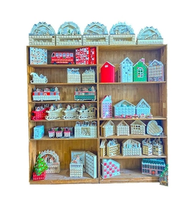 Detailed collection of wooden Christmas countdown calendars and LED crafts on display shelves