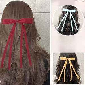 Elegant satin bow hair clip with long ribbons in red, blue and yellow variants