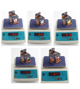 Weight measurement of five different magic cubes on scales with packaging boxes