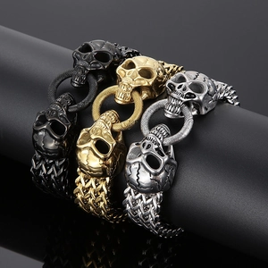 Close-up of industrial skull head bracelets in black gold and silver finishes