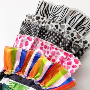 Pet dress collection featuring rainbow and heart prints with tiered ruffle design layers