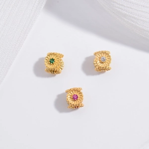 Macro view of gold-plated S925 silver flower beads with colorful gemstones for DIY