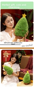 Close-up of cute plush Christmas tree toy with golden star and embroidered smiling face