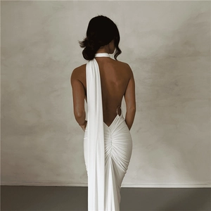 Detail of white backless evening dress with halter neck ties and metallic waist ring