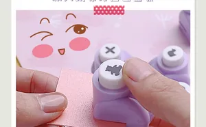 Macro detail of purple DIY craft hole puncher creating cute animal shapes on pink paper