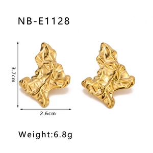 Detail view of gold twisted North Star earrings with measurements 3.7cm height and 2.6cm width