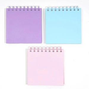 Morandi colored square spiral notebooks in purple blue and pink on white background