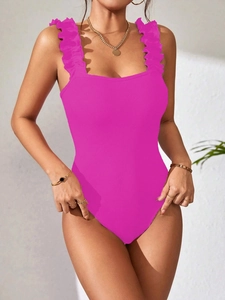 Close-up of rose pink ribbed knit bodysuit featuring elegant ruffled shoulder straps
